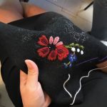 Blommor broderade på svart ylle