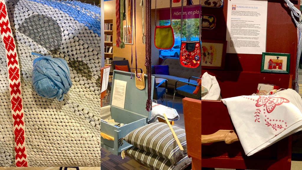 Utställning av hemslöjdsarbeten som hänger på ett bibliotek